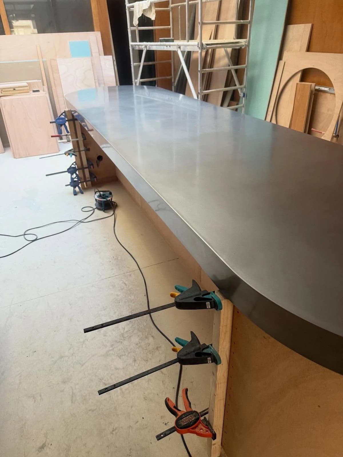 Custom stainless steel worktop held in place with clamps during fabrication