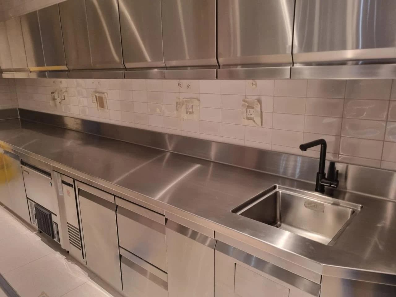 Kelvora stainless steel kitchen worktop with storage cabinets and an integrated sink
